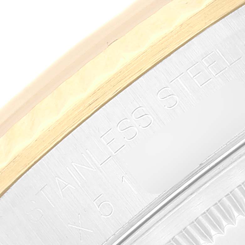 This close-up image shows the side of the bezel and part of the case of a Rolex Datejust 16233 Men's Steel and Gold (two tone) Beige Dial 16233 Men's Steel and Gold (two tone) Beige Dial watch, highlighting the "STAINLESS STEEL" engraving.
