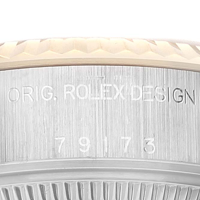 This image shows a close-up of the side of a Rolex Datejust 79173 Women's Steel and Gold (two tone) Mother of Pearl Dial 79173 Women's Steel and Gold (two tone) Mother of Pearl Dial watch case, featuring the engraved model number and design mark.