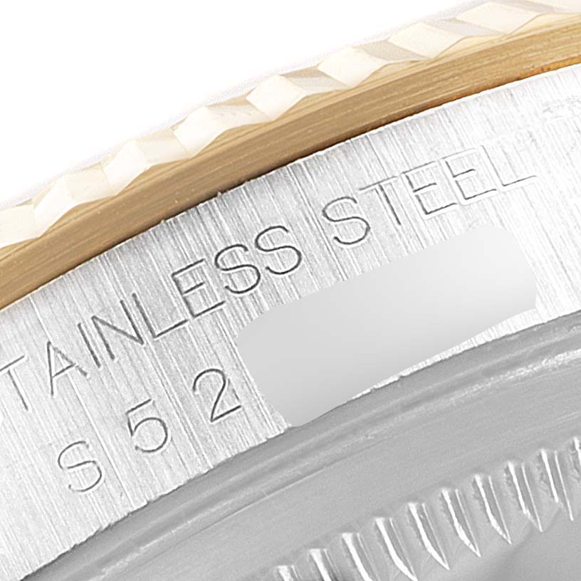 This is a close-up angle showing the side of the bezel and the engraved text "STAINLESS STEEL" on a Rolex Datejust 16233 Men's Steel and Gold (two tone) White Dial 16233 Men's Steel and Gold (two tone) White Dial watch.