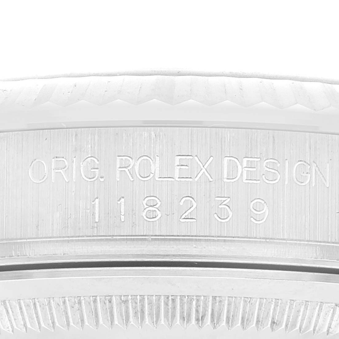 The image shows an angled close-up of the President model Rolex watch bezel, highlighting the engraved Rolex design and model number.