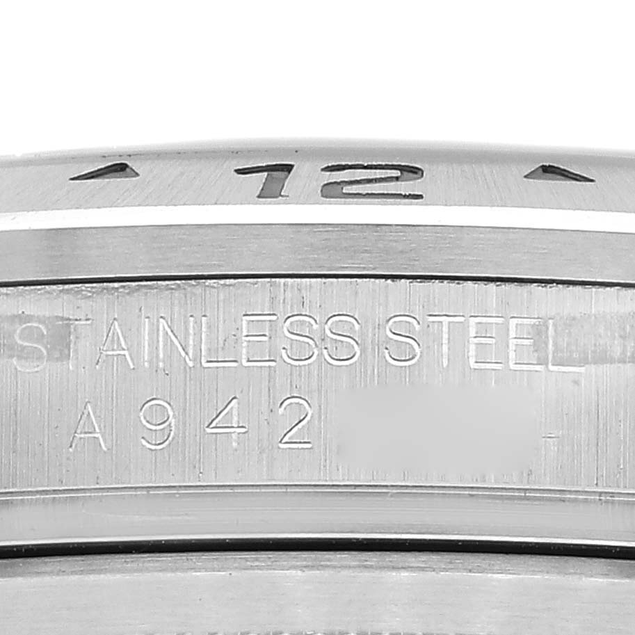 This close-up image shows the stainless steel casing and part of the bezel of the Rolex Explorer 16570 Men
s Stainless Steel Black Dial 16570 Men
s Stainless Steel Black Dial watch.