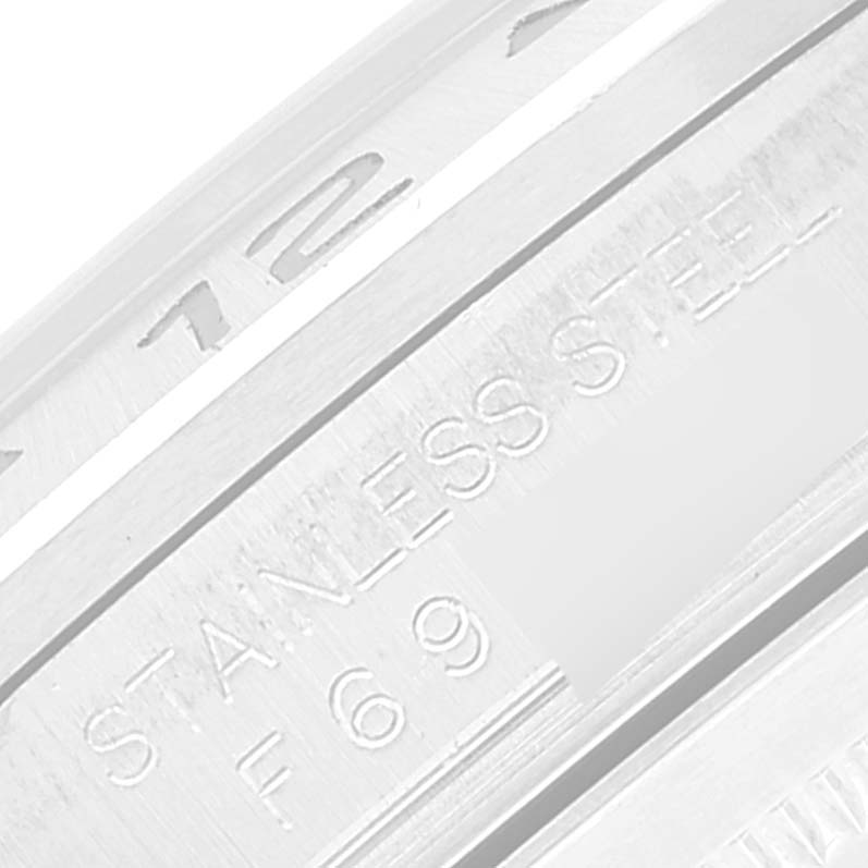 The image shows a close-up angle of the engraving on the bezel of a Rolex Explorer 16570T Men
s Stainless Steel Black Dial 16570T Men
s Stainless Steel Black Dial watch, including parts of the serial number and material details.