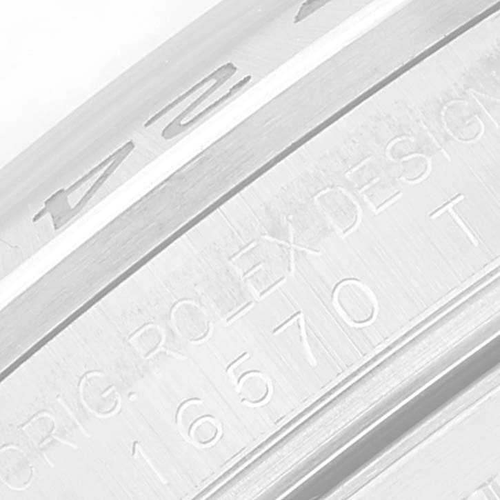 The image shows an engraved side view of the bezel of a Rolex Explorer 16570T Men
s Stainless Steel Black Dial 16570T Men
s Stainless Steel Black Dial watch.