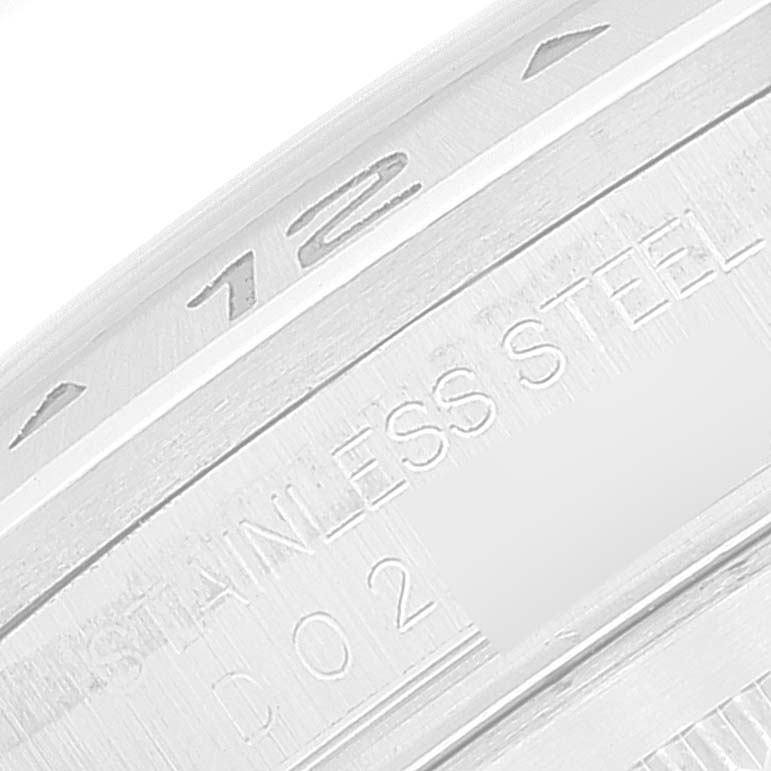 The image shows a close-up of the bezel and inner edge of a Rolex Explorer 16570T Men
s Stainless Steel Black Dial 16570T Men
s Stainless Steel Black Dial watch with "STAINLESS STEEL" engraved.