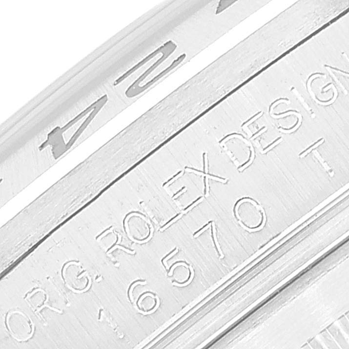 This image shows an engraved side view of the casing of a Rolex Explorer 16570T Men
s Stainless Steel Black Dial 16570T Men
s Stainless Steel Black Dial watch, revealing the model number and the "Rolex Design" inscription.