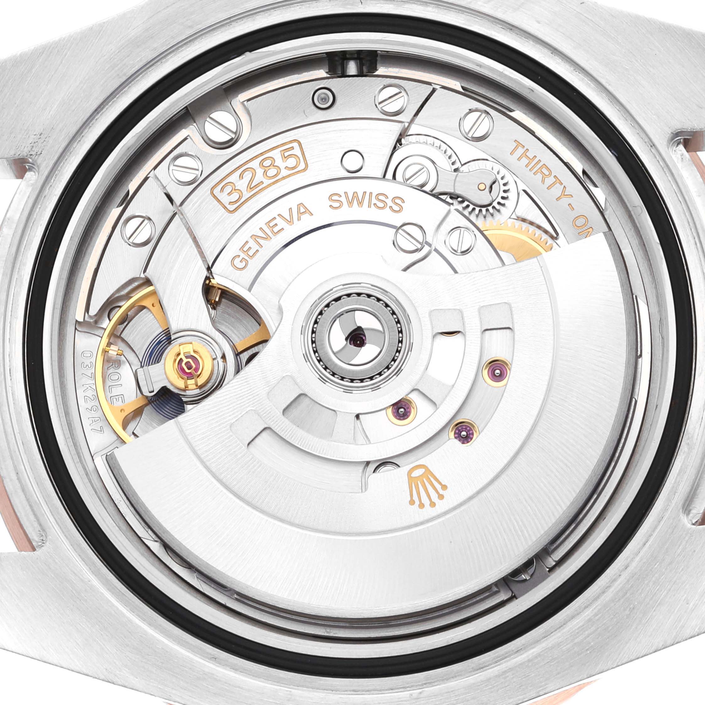 The image shows a close-up of the movement and inner mechanisms of a Rolex GMT-Master 126711CHNR Men's Steel and Gold (two tone) Black Dial 126711CHNR Men's Steel and Gold (two tone) Black Dial watch.