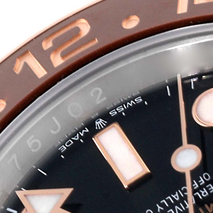 This close-up image shows part of the bezel, dial, and hands of a Rolex GMT-Master 126711CHNR Men's Steel and Gold (two tone) Black Dial 126711CHNR Men's Steel and Gold (two tone) Black Dial watch.