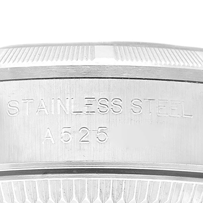 This image shows a close-up view of the side and case back of a Rolex Oyster Perpetual 76030 Women's Stainless Steel Orange Dial 76030 Women's Stainless Steel Orange Dial watch, highlighting the stainless steel engraving.