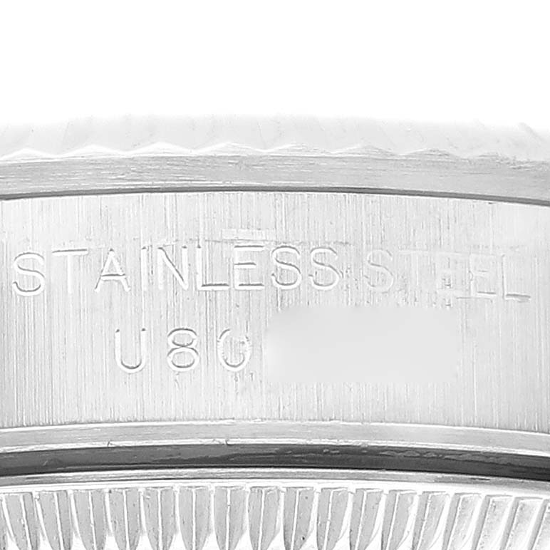 The image shows a close-up of the side engraving on a Rolex Oyster Perpetual 67194 Women's Stainless Steel Orange Dial 67194 Women's Stainless Steel Orange Dial watch, highlighting the "STAINLESS STEEL" mark.