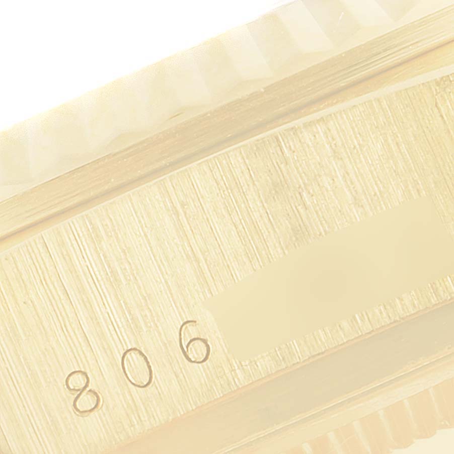 This image shows a close-up of the side of the Rolex President 18038 Men
s Yellow Gold White Dial 18038 Men
s Yellow Gold White Dial watch, highlighting the engraved serial number.