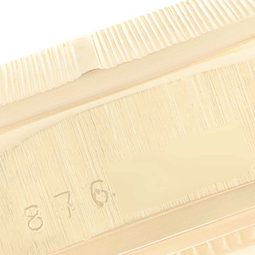 This image shows a close-up of the bezel and serial number on the side case of a Rolex President 18078 Men's Yellow Gold Blue Dial 18078 Men's Yellow Gold Blue Dial model watch.