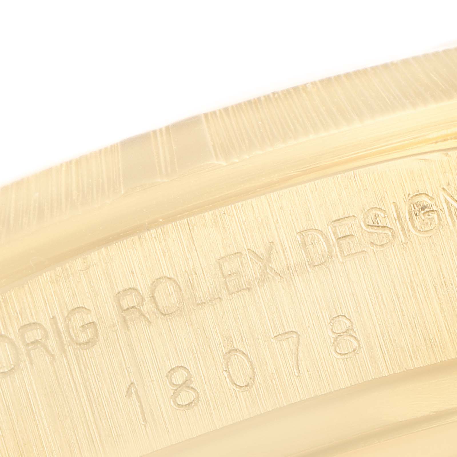 The image shows a close-up of the serial number and engraving on the case side of a Rolex President 18078 Men's Yellow Gold Blue Dial 18078 Men's Yellow Gold Blue Dial model watch.