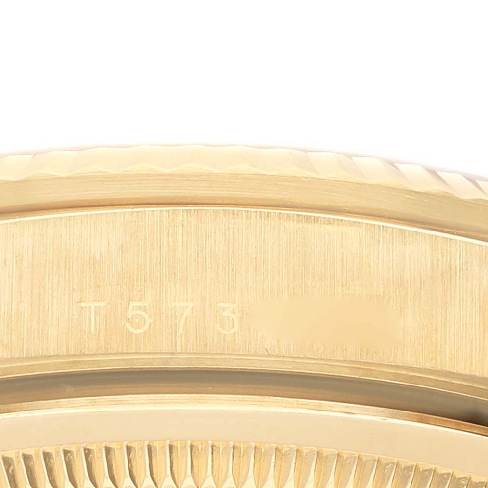 This image shows a close-up of the serial number engraving on the case of a Rolex President 18238 Men
s Yellow Gold White Dial 18238 Men
s Yellow Gold White Dial model watch.