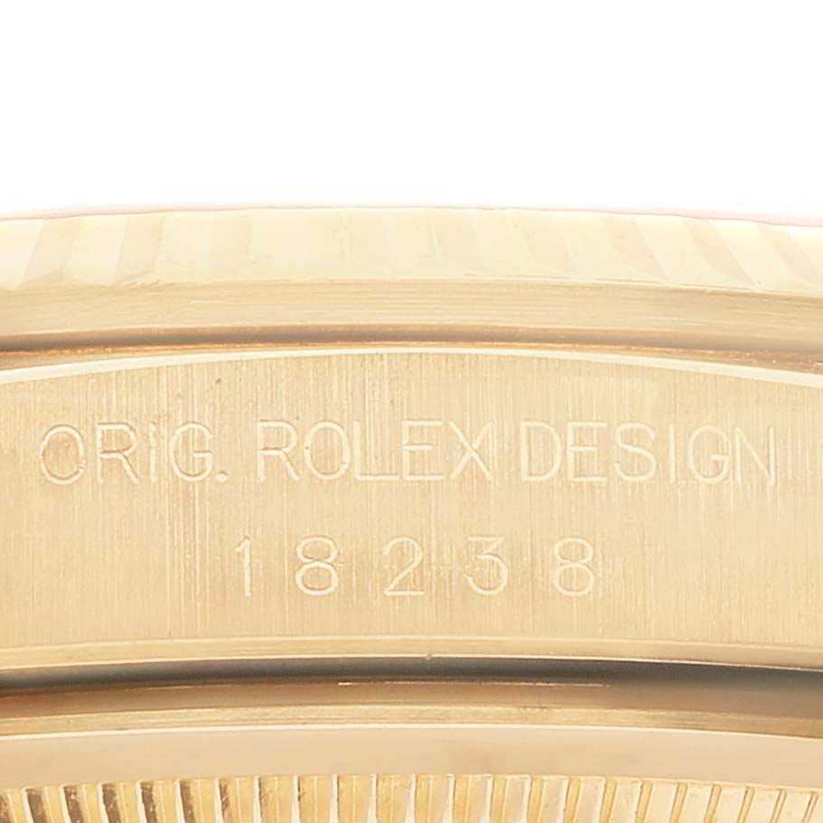 This image shows a close-up of the engraved case back and upper bezel of a Rolex President 18238 Men
s Yellow Gold White Dial 18238 Men
s Yellow Gold White Dial model watch.