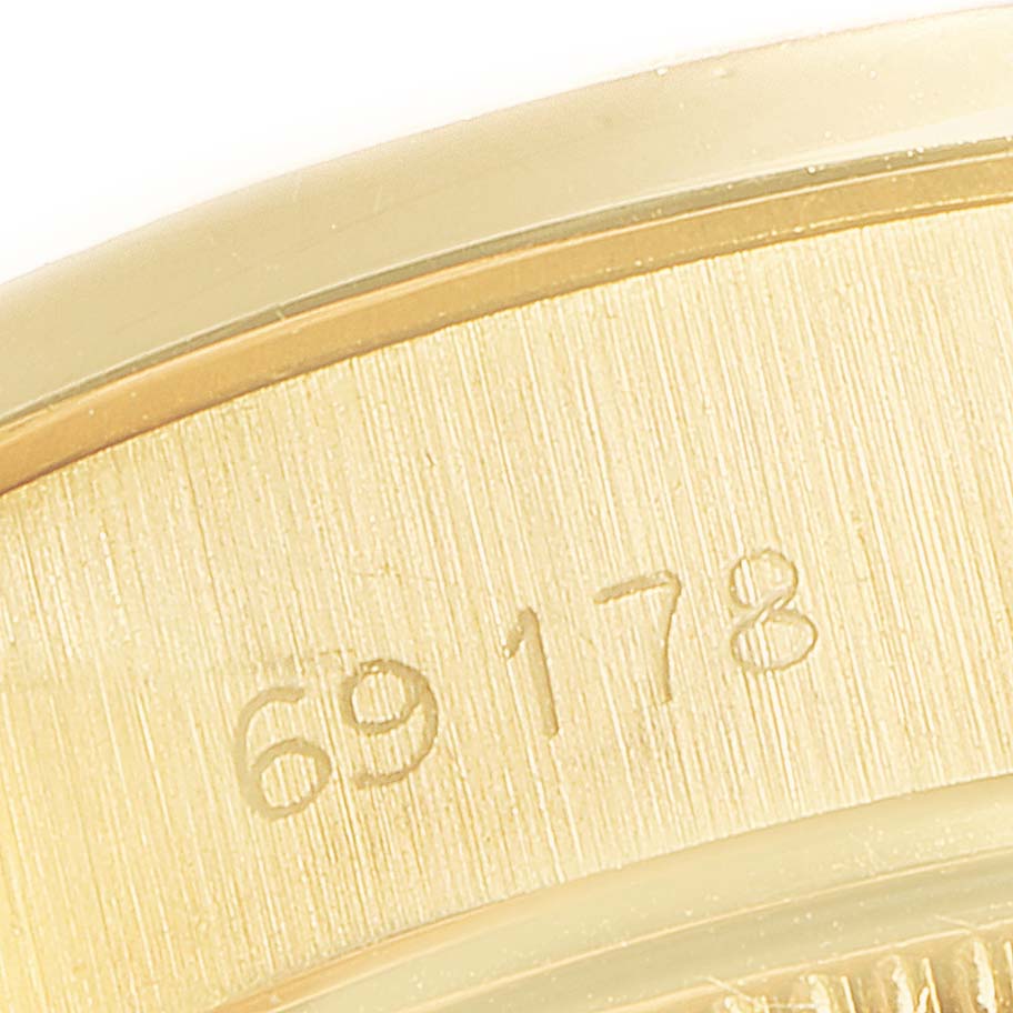 This close-up image of the Rolex President 69178 Women
s Yellow Gold Champagne Dial 69178 Women
s Yellow Gold Champagne Dial model watch shows the engraved model number.