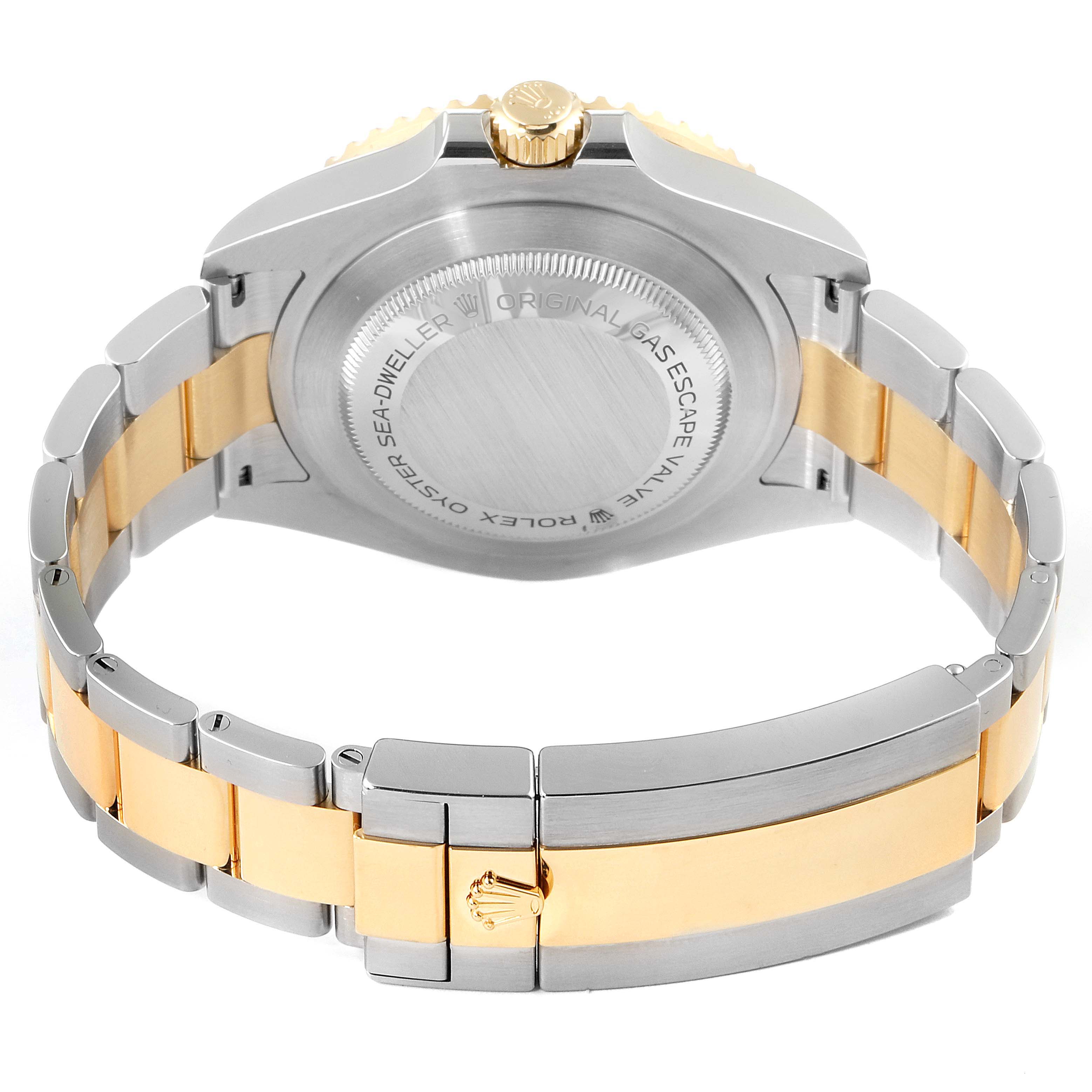 This image shows the back angle of the Rolex Sea-Dweller 126603 Men
s Steel and Gold (two tone) Black Dial 126603 Men
s Steel and Gold (two tone) Black Dial watch, highlighting its case back and two-tone bracelet.