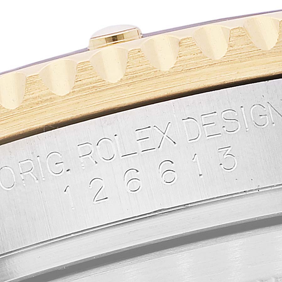 The image shows a close-up of the side of a Rolex Submariner 126613 Men's Steel and Gold (two tone) Blue Dial 126613 Men's Steel and Gold (two tone) Blue Dial watch, highlighting the model number and part of the bezel.
