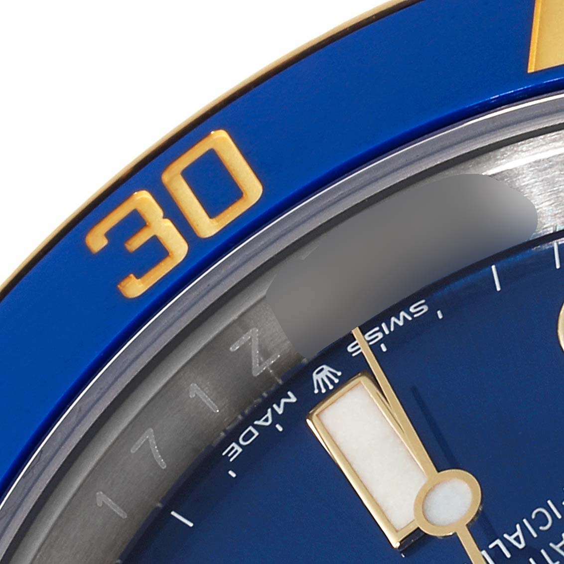 This close-up image shows the blue and gold bezel, part of the dial, and the hour hand of a Rolex Submariner 126613 Men's Steel and Gold (two tone) Blue Dial 126613 Men's Steel and Gold (two tone) Blue Dial watch.