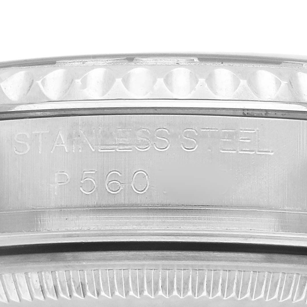 The image shows a close-up of the edge of the Yacht-Master watch by Rolex, highlighting the stainless steel engraving and part of the bezel.