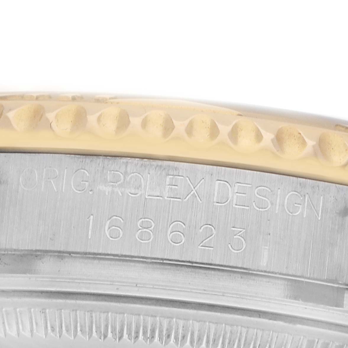 The image shows a partial side view of the Rolex Yacht-Master 168623 Men's Steel and Gold (two tone) Champagne Dial's engraved edge and case with the model number visible.