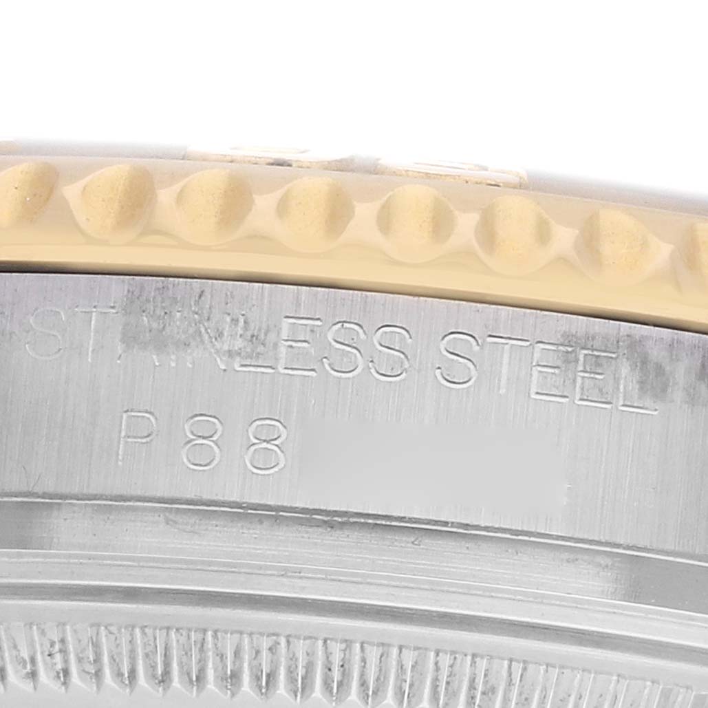 The image shows a close-up of the Rolex Yacht-Master 168623 Men's Steel and Gold (two tone) Champagne Dial watch's side, featuring the bezel and engraved stainless steel markings.