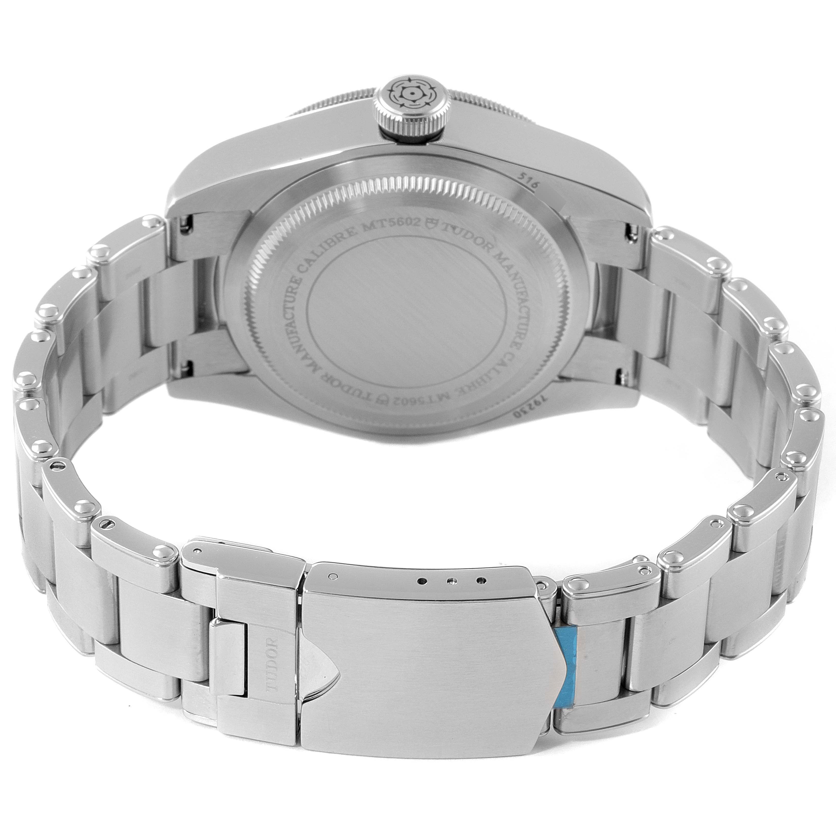 The image shows the rear view of the Tudor Heritage Black Bay 79230B Men
s Stainless Steel Black Dial 79230B Men
s Stainless Steel Black Dial watch, focusing on the stainless steel case back, crown, and bracelet clasp.