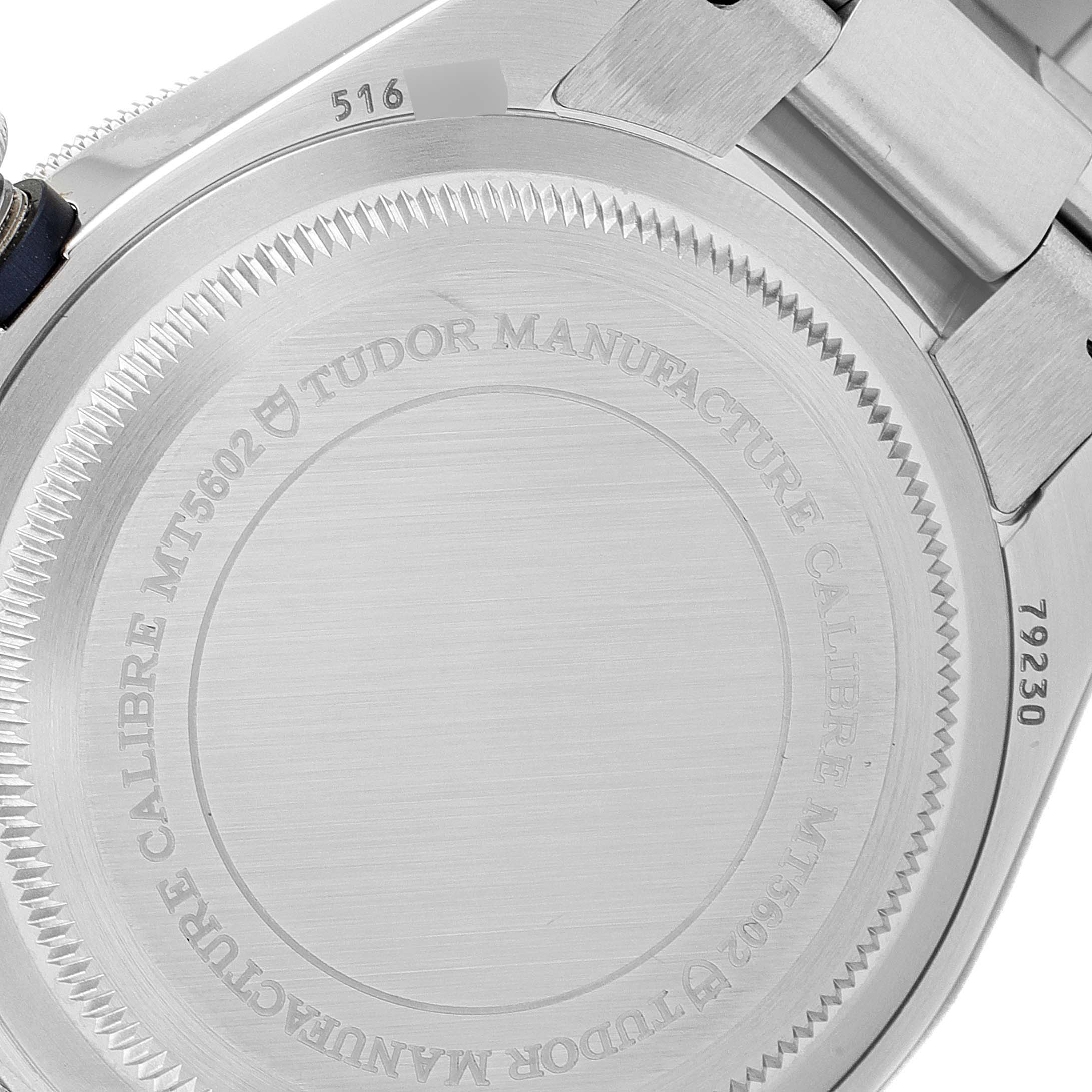 This image shows the back case of a Tudor Heritage Black Bay 79230B Men
s Stainless Steel Black Dial 79230B Men
s Stainless Steel Black Dial watch, displaying engravings and part of the bracelet.