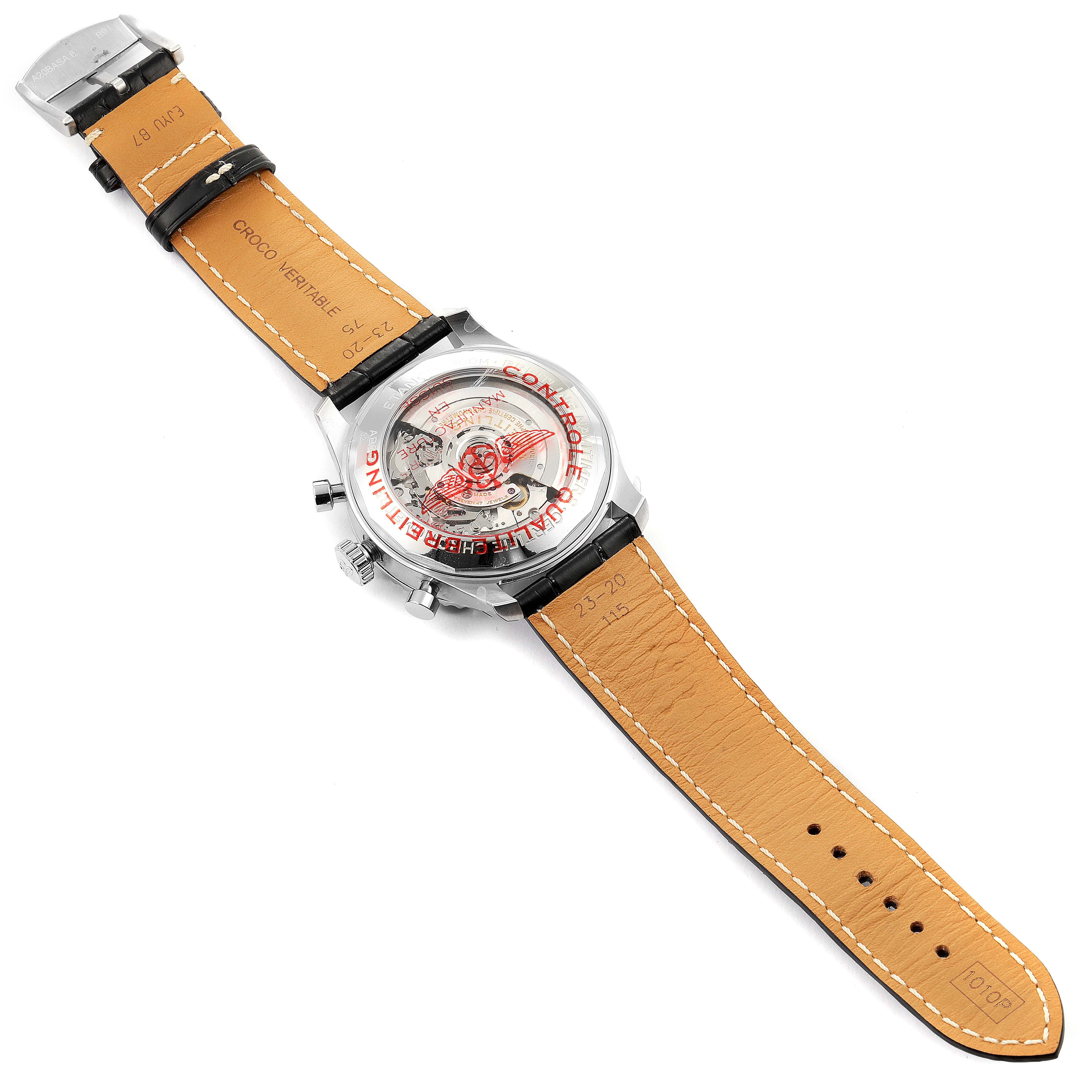 The image shows the back view of a Breitling Navitimer watch, highlighting the movement and leather strap.