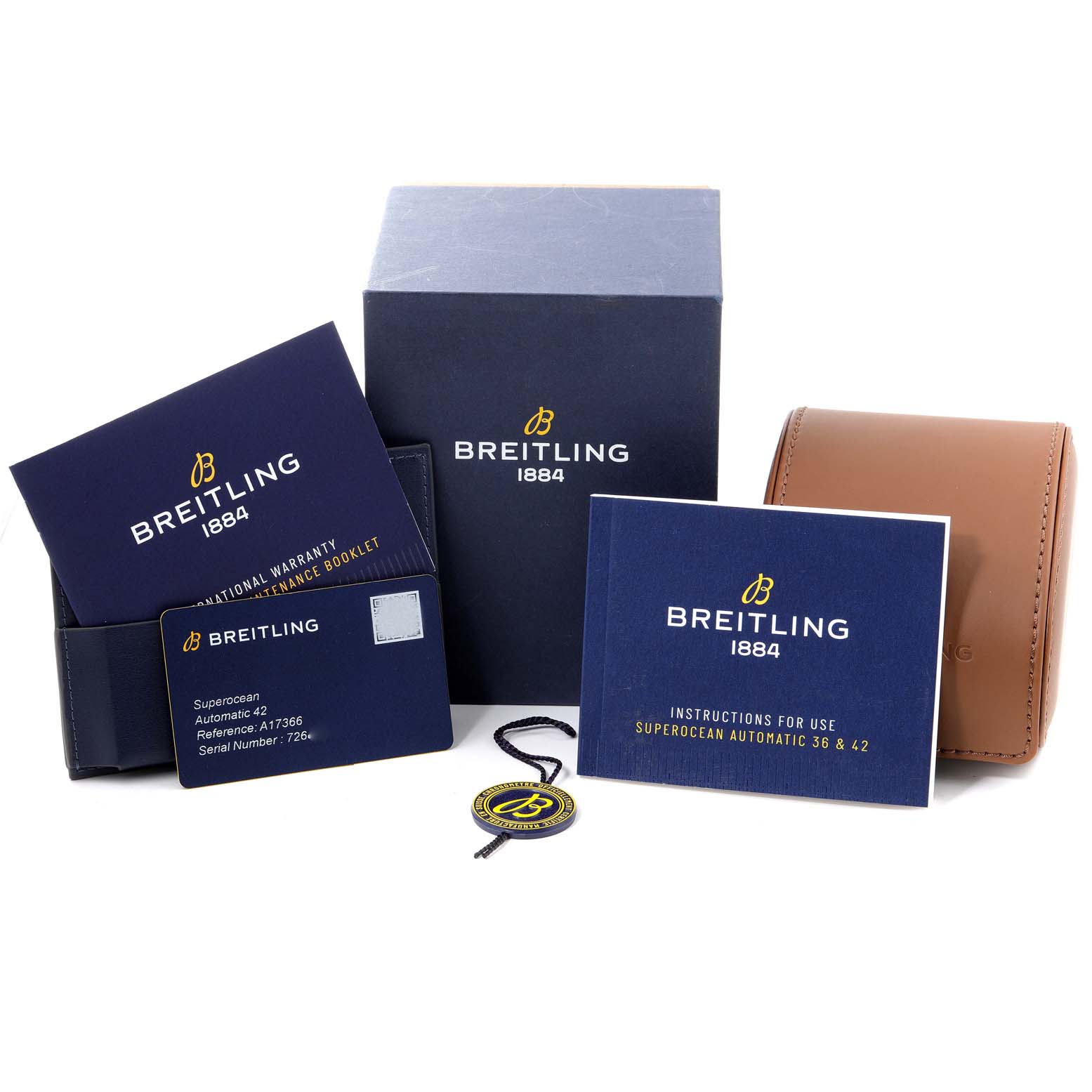 The image shows the packaging and accessories for the Breitling Superocean A17366 Men
s Stainless Steel White Dial A17366 Men
s Stainless Steel White Dial model, including instruction booklets, warranty card, tag, and leather case.