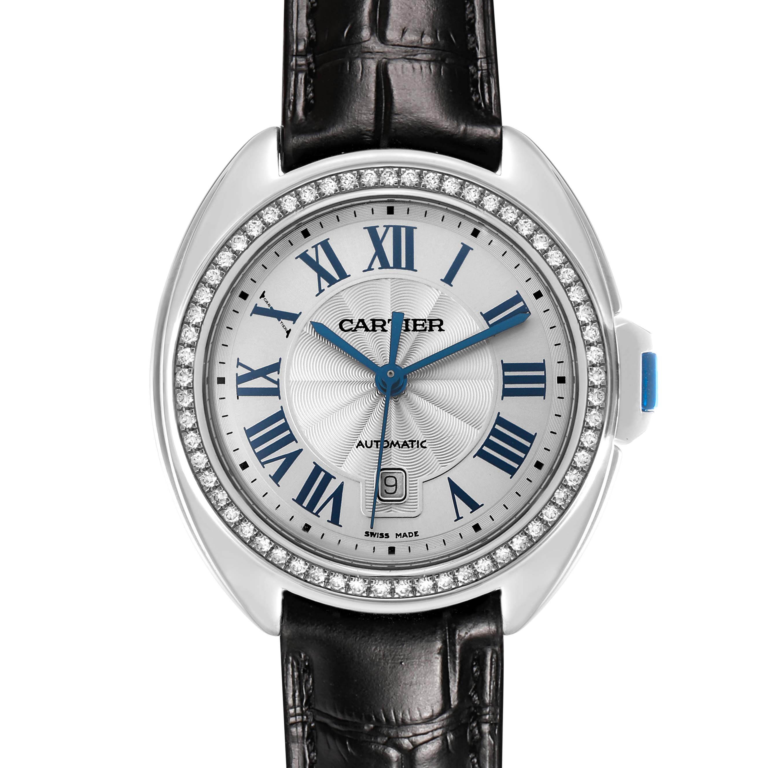 The Cartier Clé watch is shown from the front, highlighting its Roman numeral dial, diamond bezel, and black leather strap.