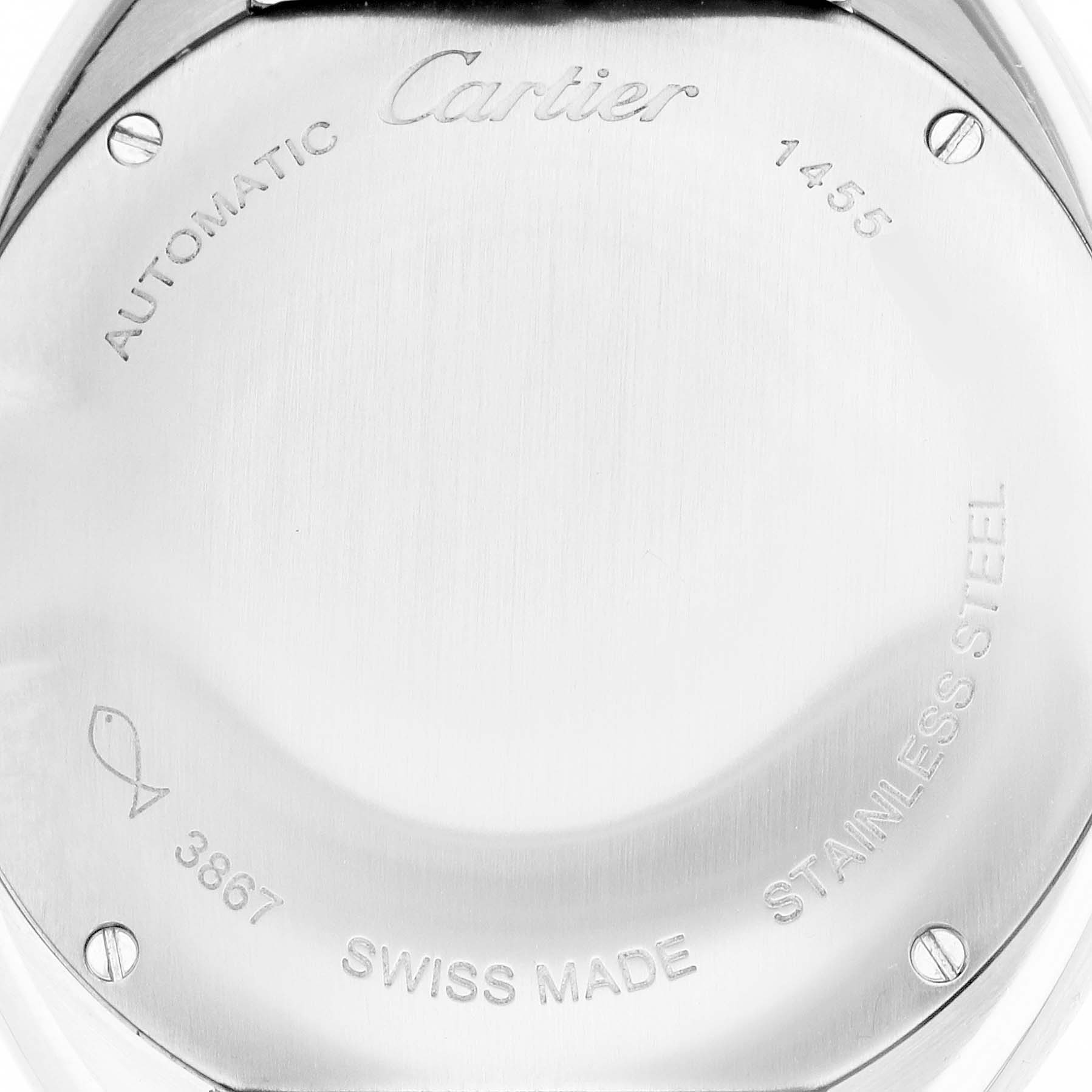 The image shows the back of a Cartier Clé watch, featuring inscriptions and screws.