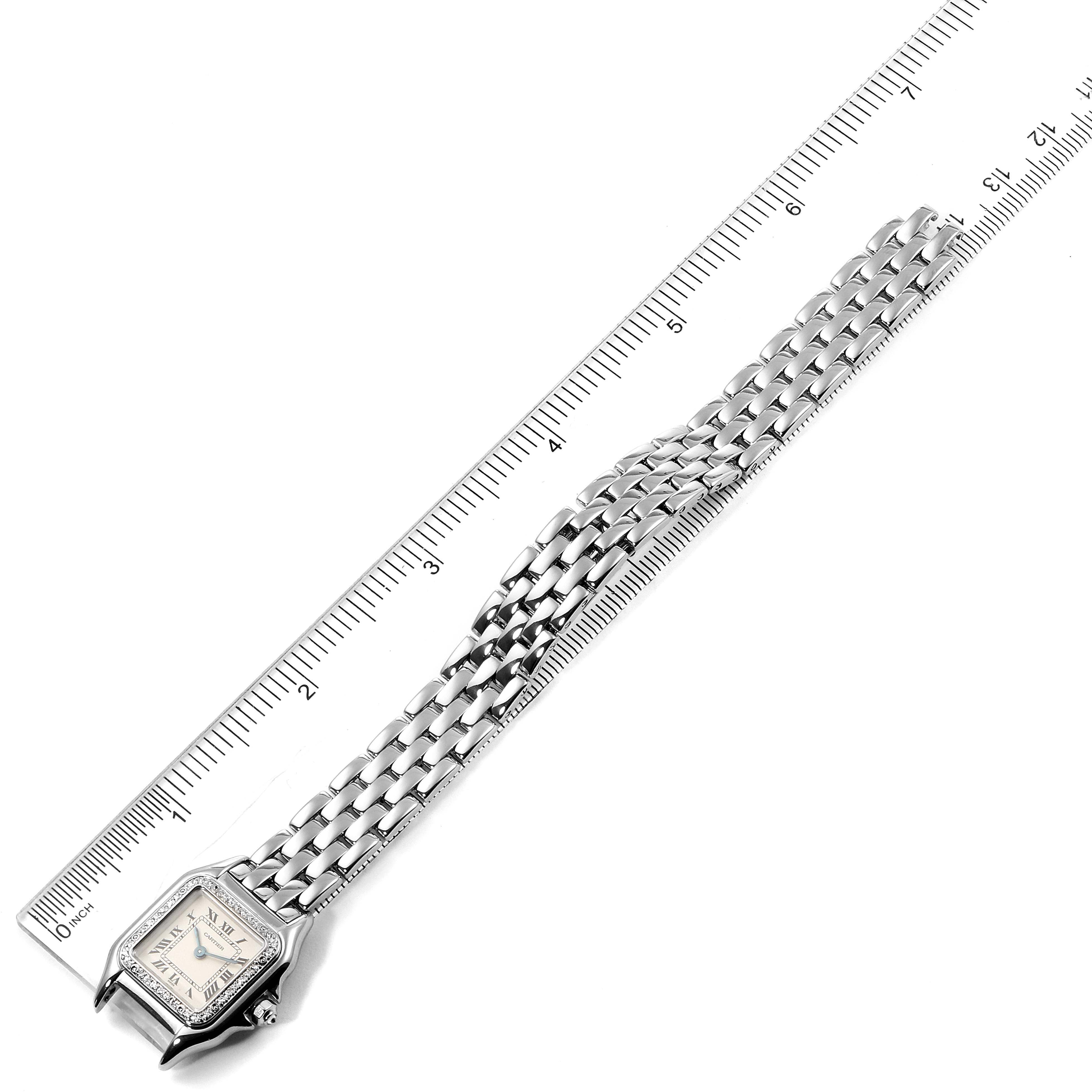 The image shows a Panthère de Cartier watch laid flat with a ruler, displaying the face and metal bracelet from a top-down angle.