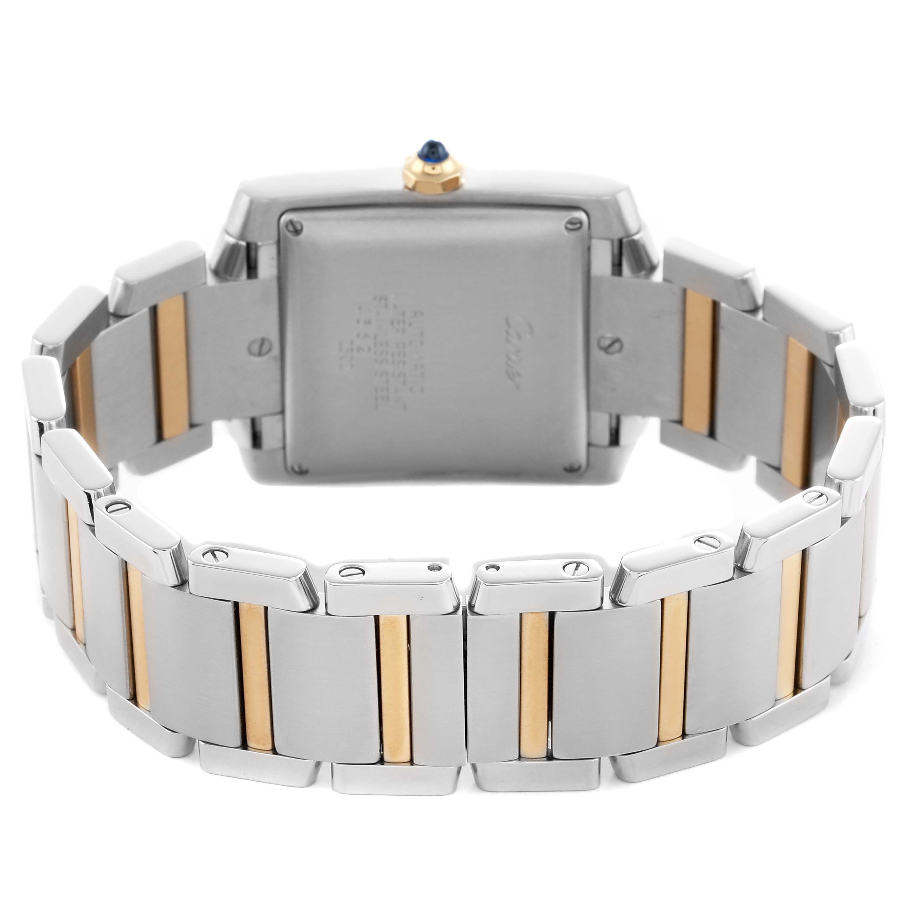The image shows the back case and bracelet of a Cartier Tank Française watch, highlighting its two-tone metal links.
