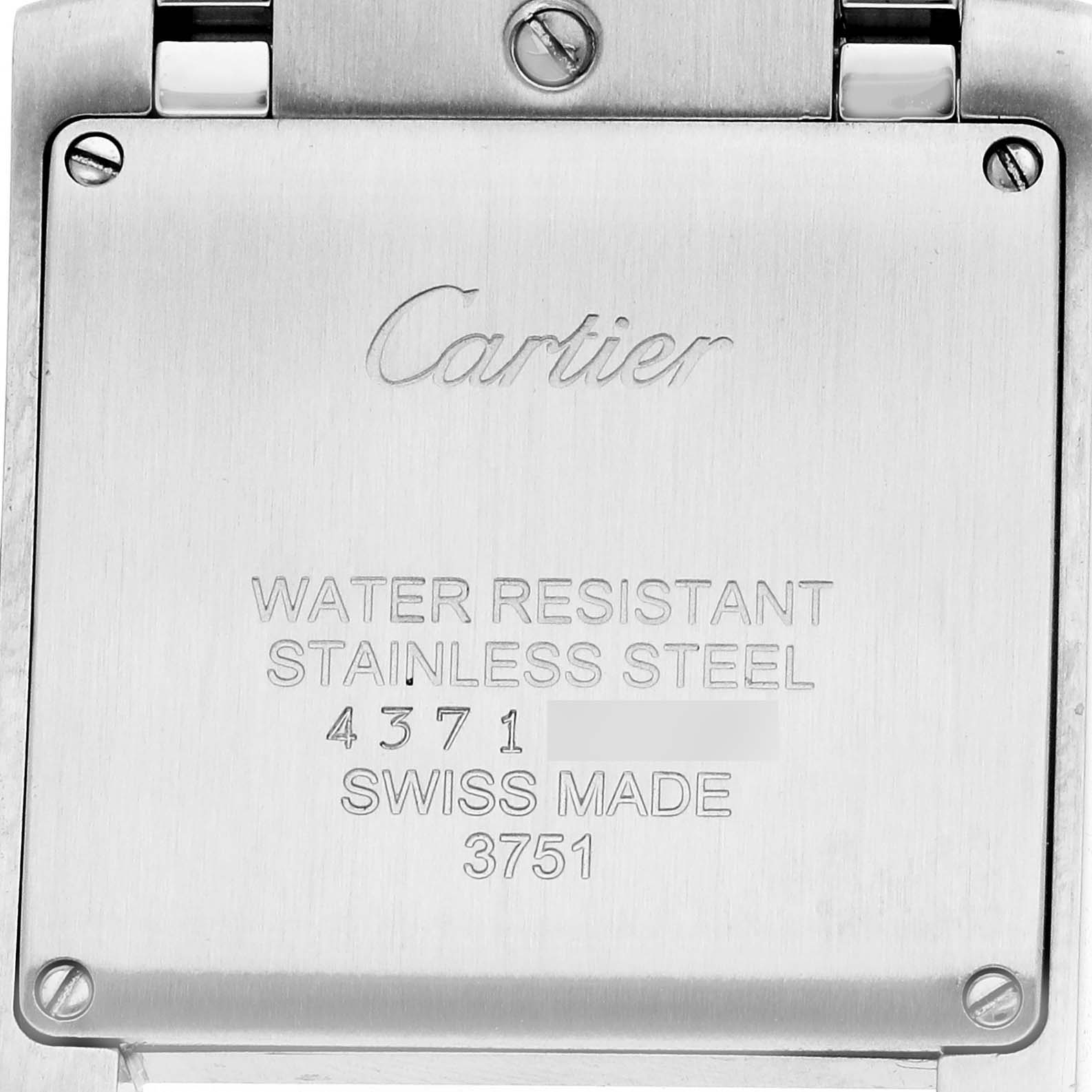 The image shows the back case of a Cartier Tank Française watch with engravings and screws visible.