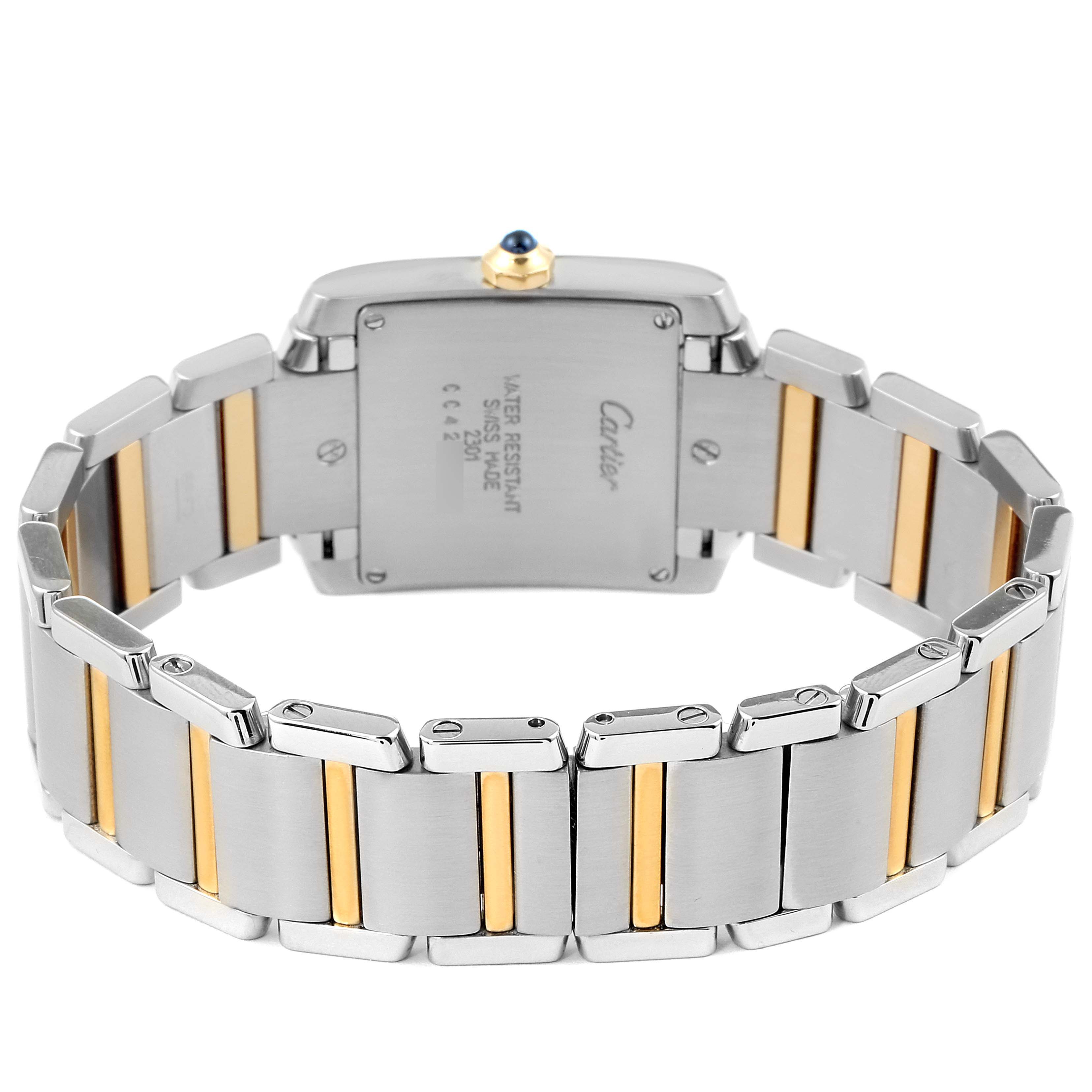 The image shows the back and bracelet of a Cartier Tank Française watch, highlighting its two-tone metal links and inscription on the case back.