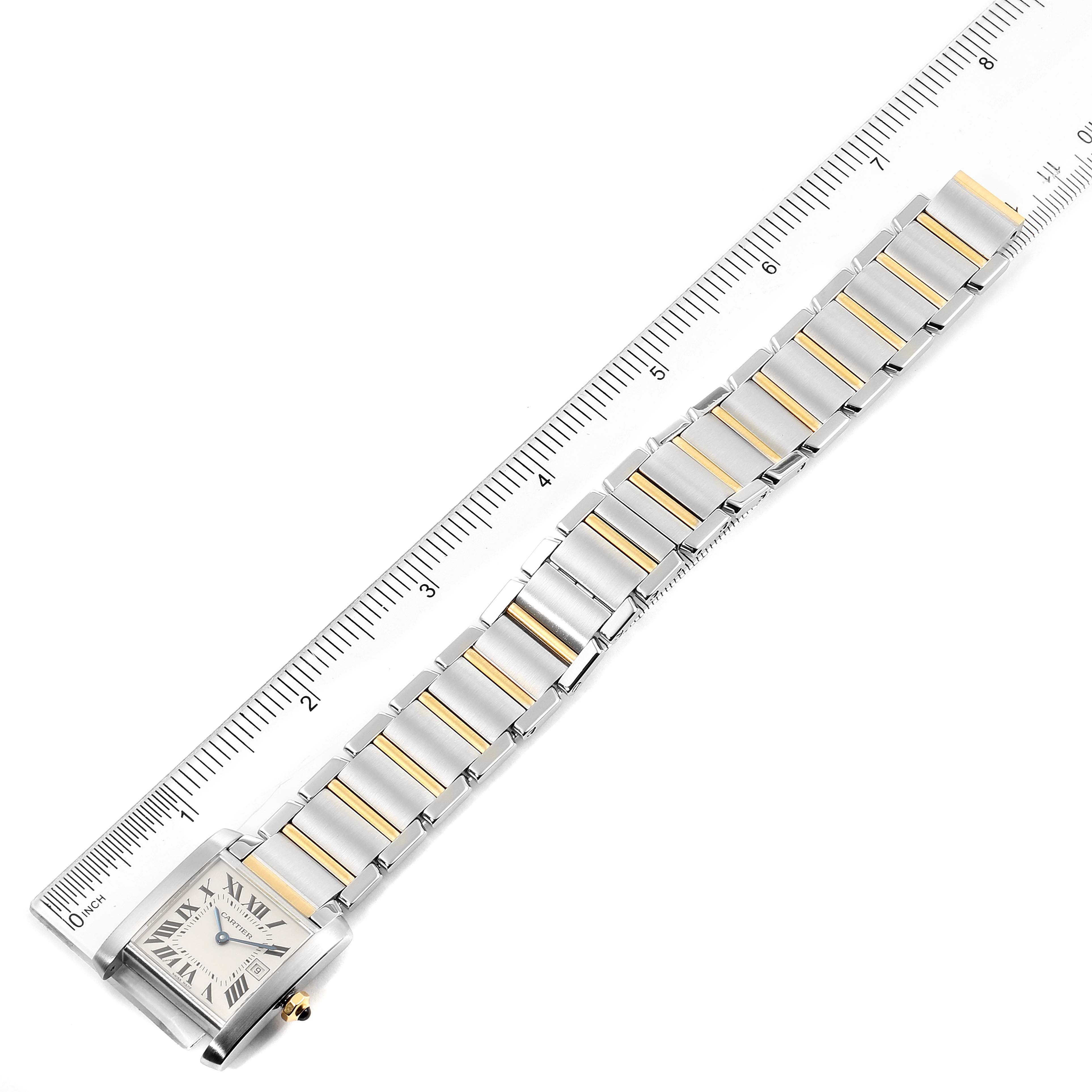 This image shows a Tank Francaise watch by Cartier, including the case, dial, and bracelet, aligned with a ruler for measurement.