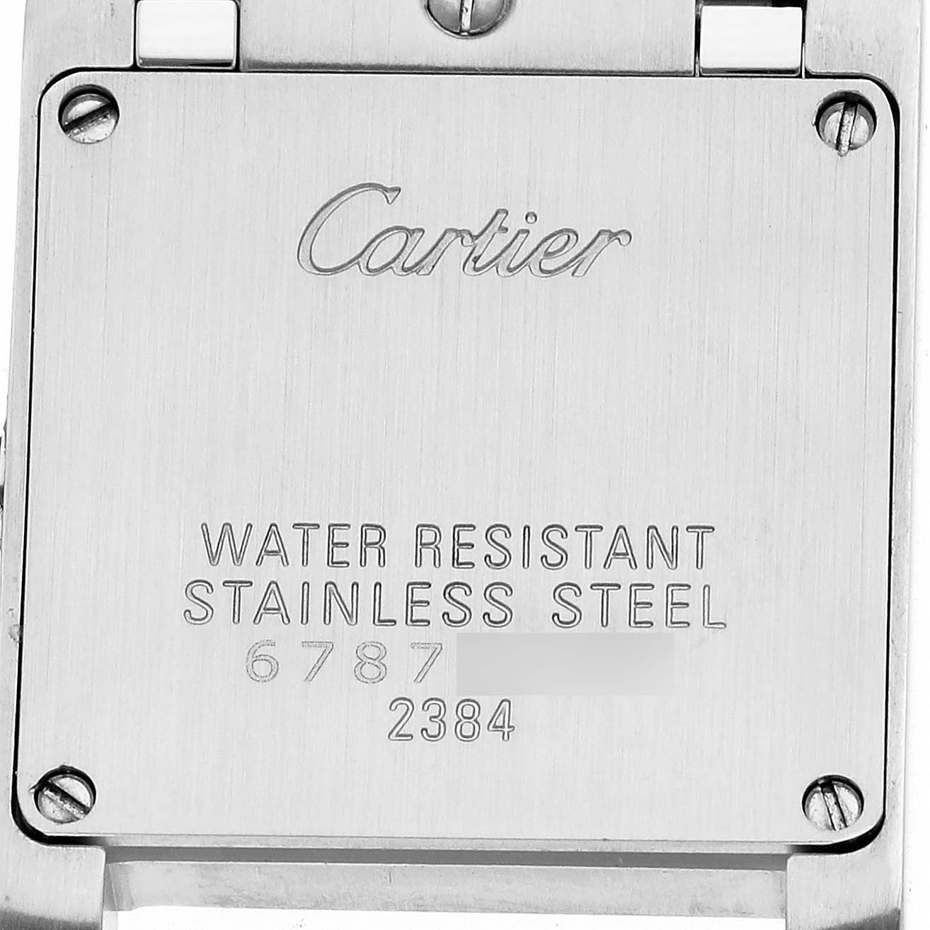 The image shows the back of a Cartier Tank Française watch with engravings and screws visible.