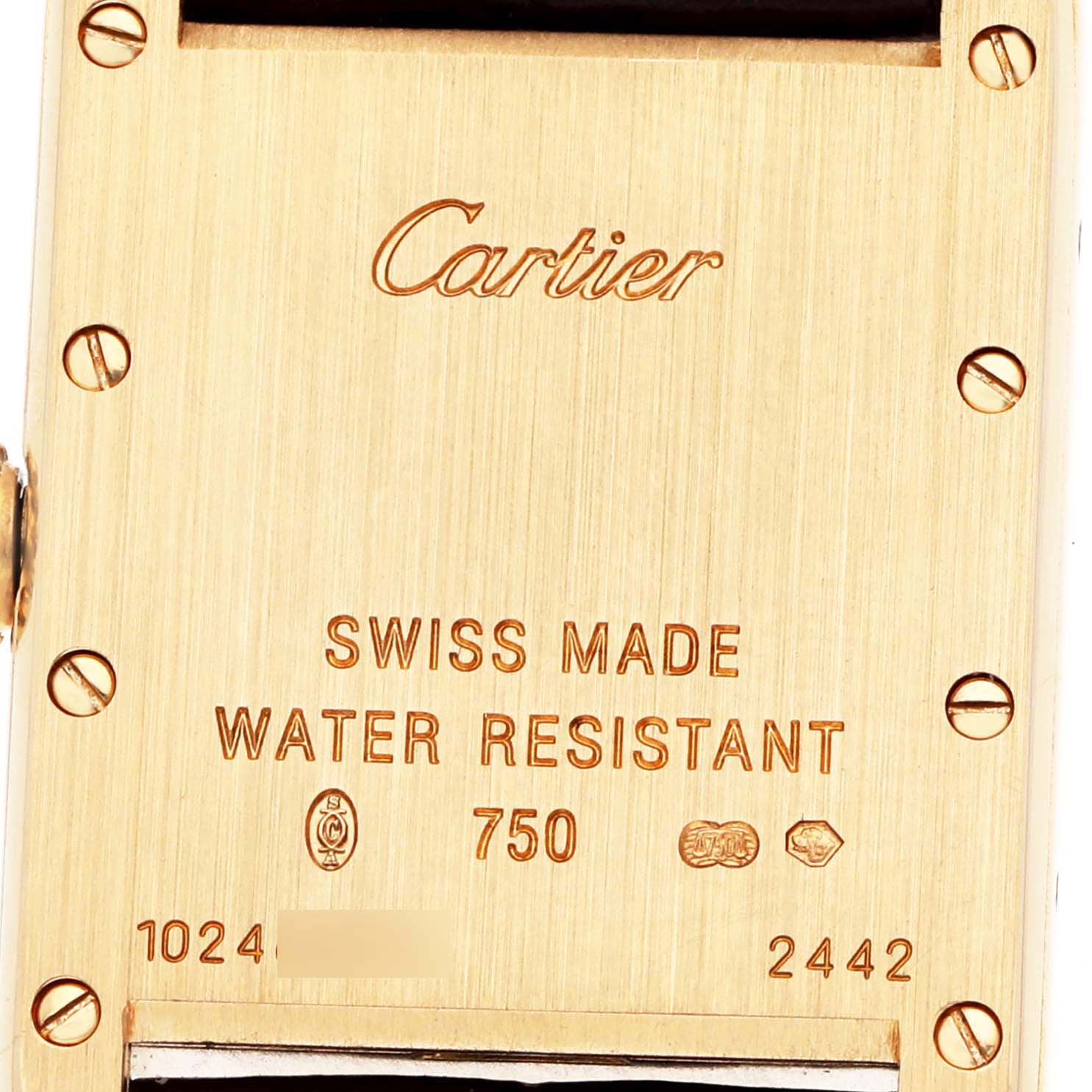 The image shows the back of a Cartier Tank Louis W1529856 Women's Yellow Gold Silver Dial watch, displaying engravings and screws.