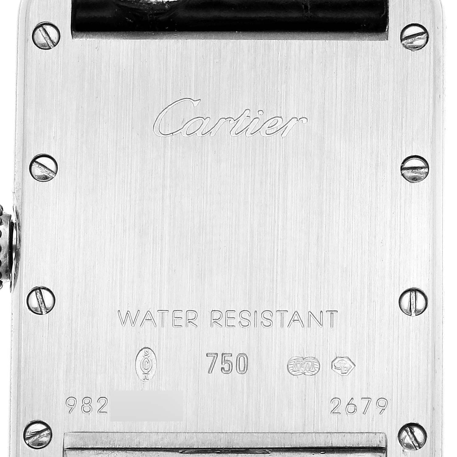 The image shows the back of a Cartier Tank Louis W1541056 Women's White Gold Silver Dial watch, featuring engravings and screws.