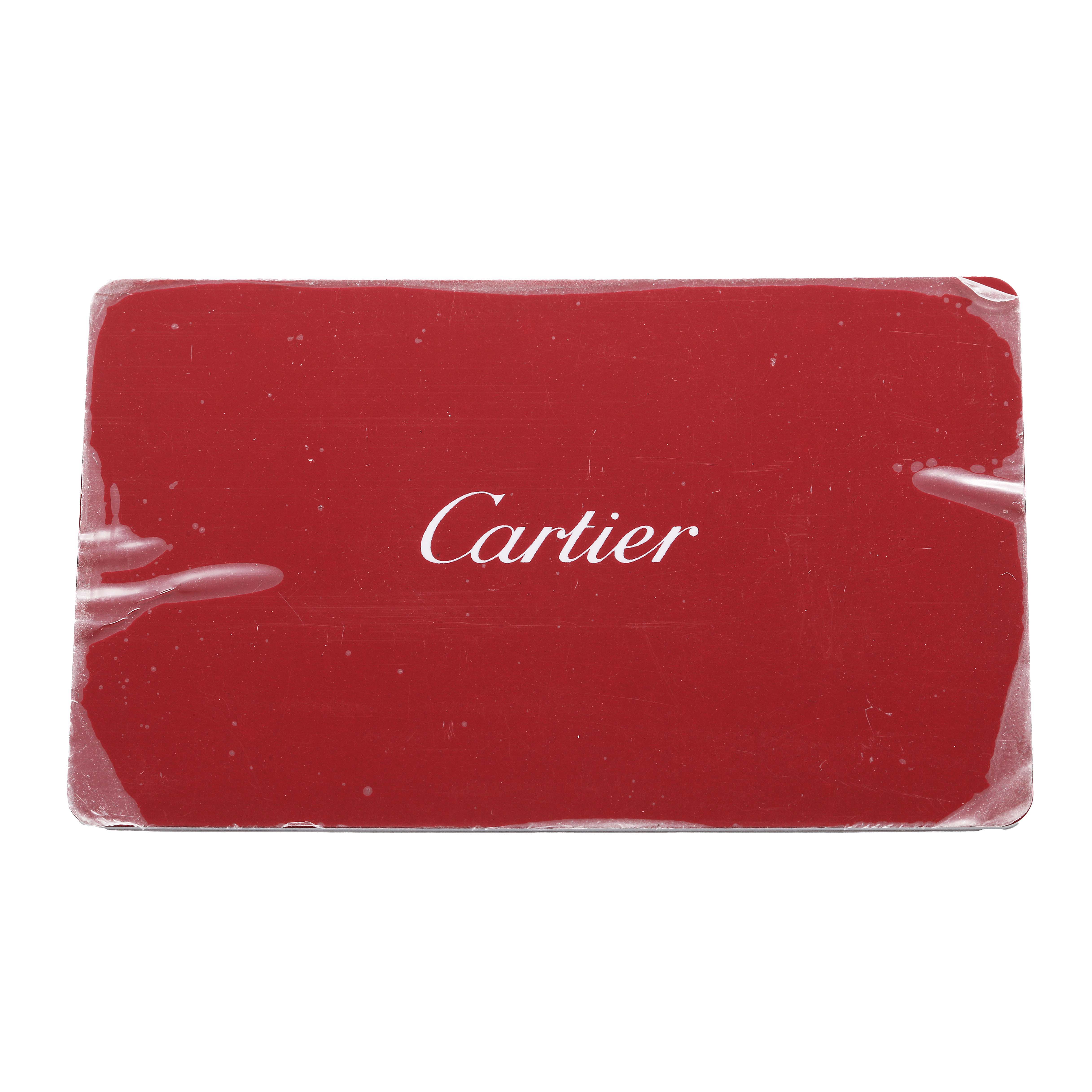 This image shows a red card with the "Cartier" logo, likely an accessory for the Tank Must model by Cartier.