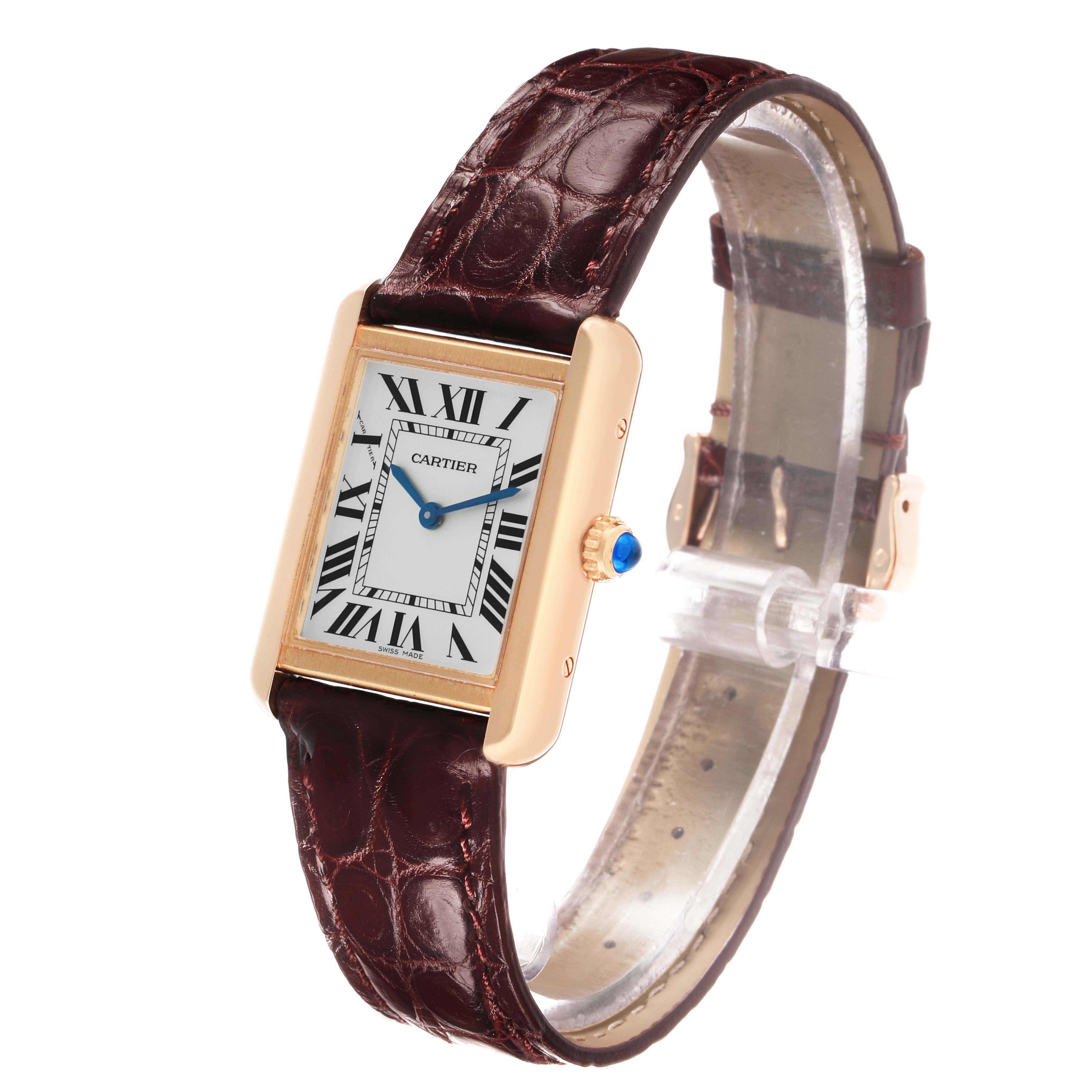 The Cartier Tank Solo W5200024 Women's Rose Gold Silver Dial watch is shown at an angle, highlighting its rectangular face, Roman numerals, gold case, and brown leather strap.