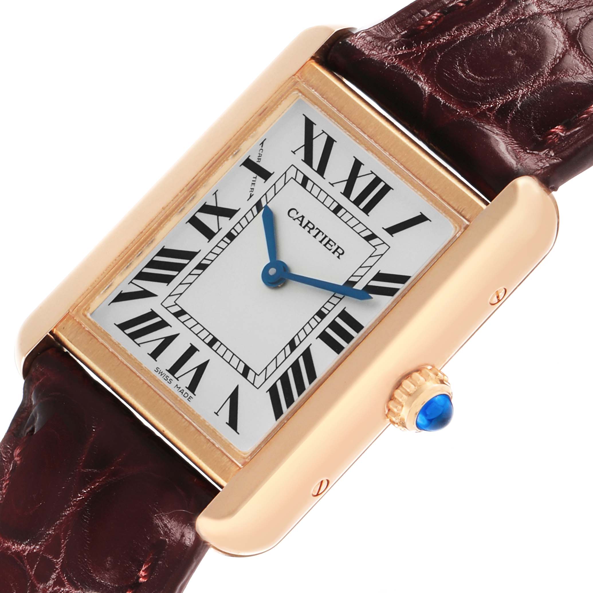 The Cartier Tank Solo W5200024 Women's Rose Gold Silver Dial watch is shown from a slight angle, highlighting its rectangular face, Roman numerals, and blue cabochon crown.