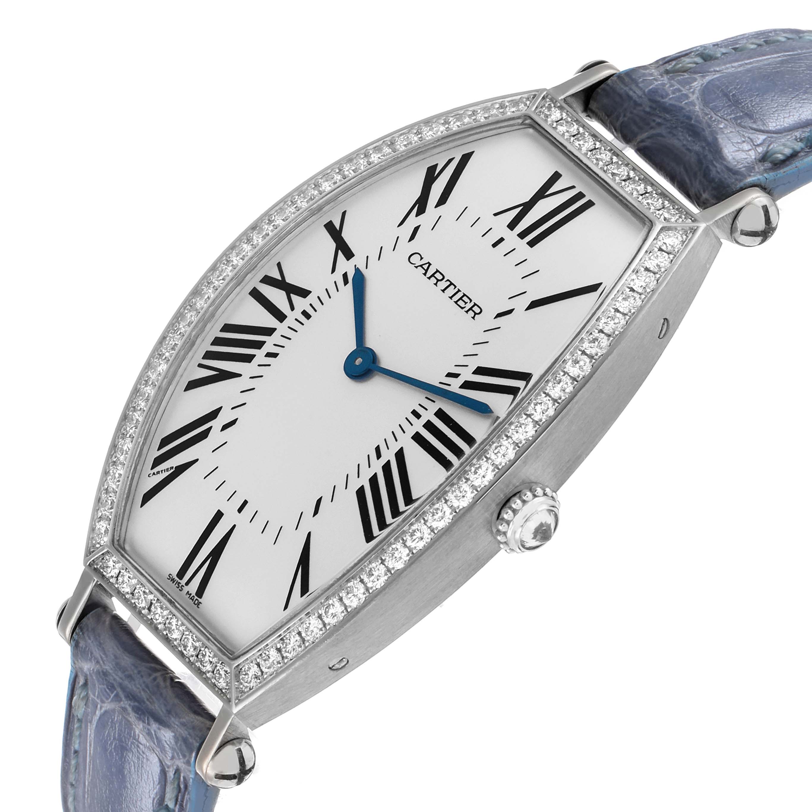 The Cartier Tonneau WE400251 Women's White Gold Silver Dial watch is shown at an angled side view, highlighting its oval face, Roman numerals, and diamond bezel.