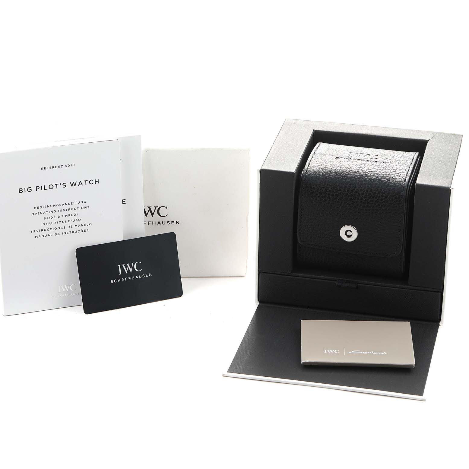 The image shows the IWC Pilot IW501002 Men's Stainless Steel Blue Dial watch accessories, including a box, manual, case, and warranty card with a front-facing angle.