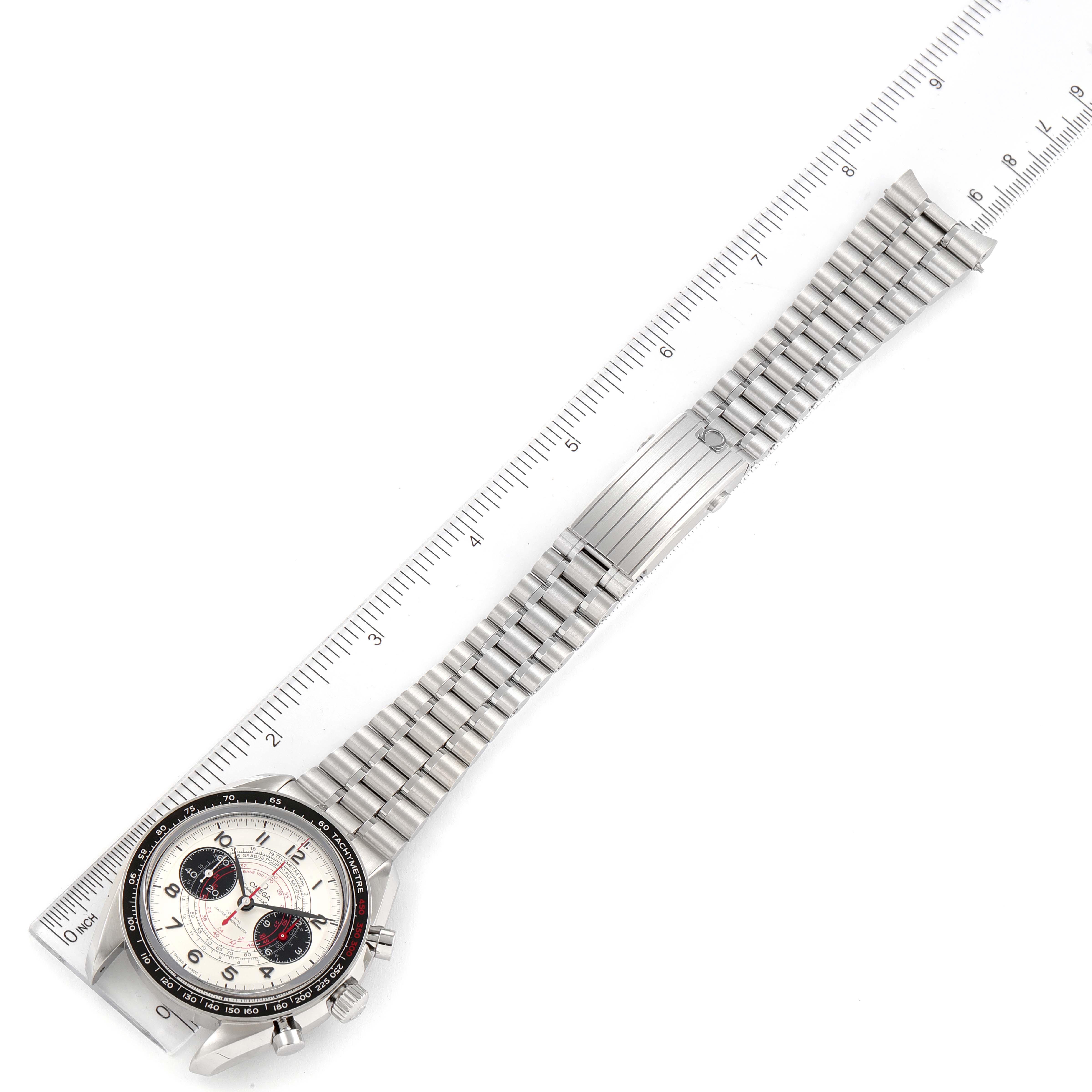 The image shows an Omega Speedmaster 329.30.43.51.02.002 Men's Stainless Steel Silver Dial 329.30.43.51.02.002 Men's Stainless Steel Silver Dial watch laid flat with its silver metal bracelet extended, alongside a ruler for measurement.
