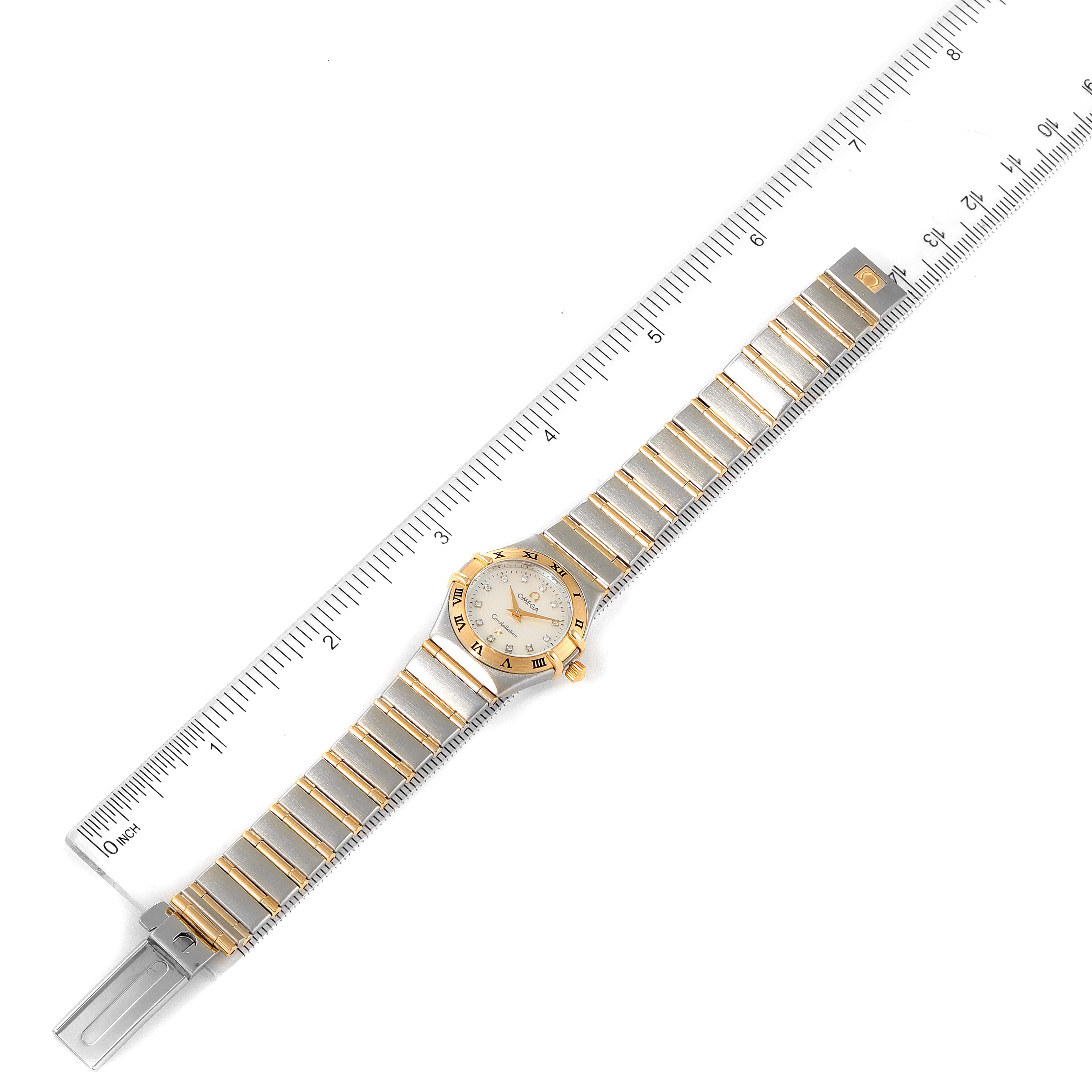 The image shows an Omega 1262.75.00 Women
s Steel and Gold (two tone) Mother of Pearl Dial 1262.75.00 Women
s Steel and Gold (two tone) Mother of Pearl Dial Constellation Steel Yellow Gold MOP Diamond Ladies Watch 1262.75.00 flat, with a ruler indicating length.