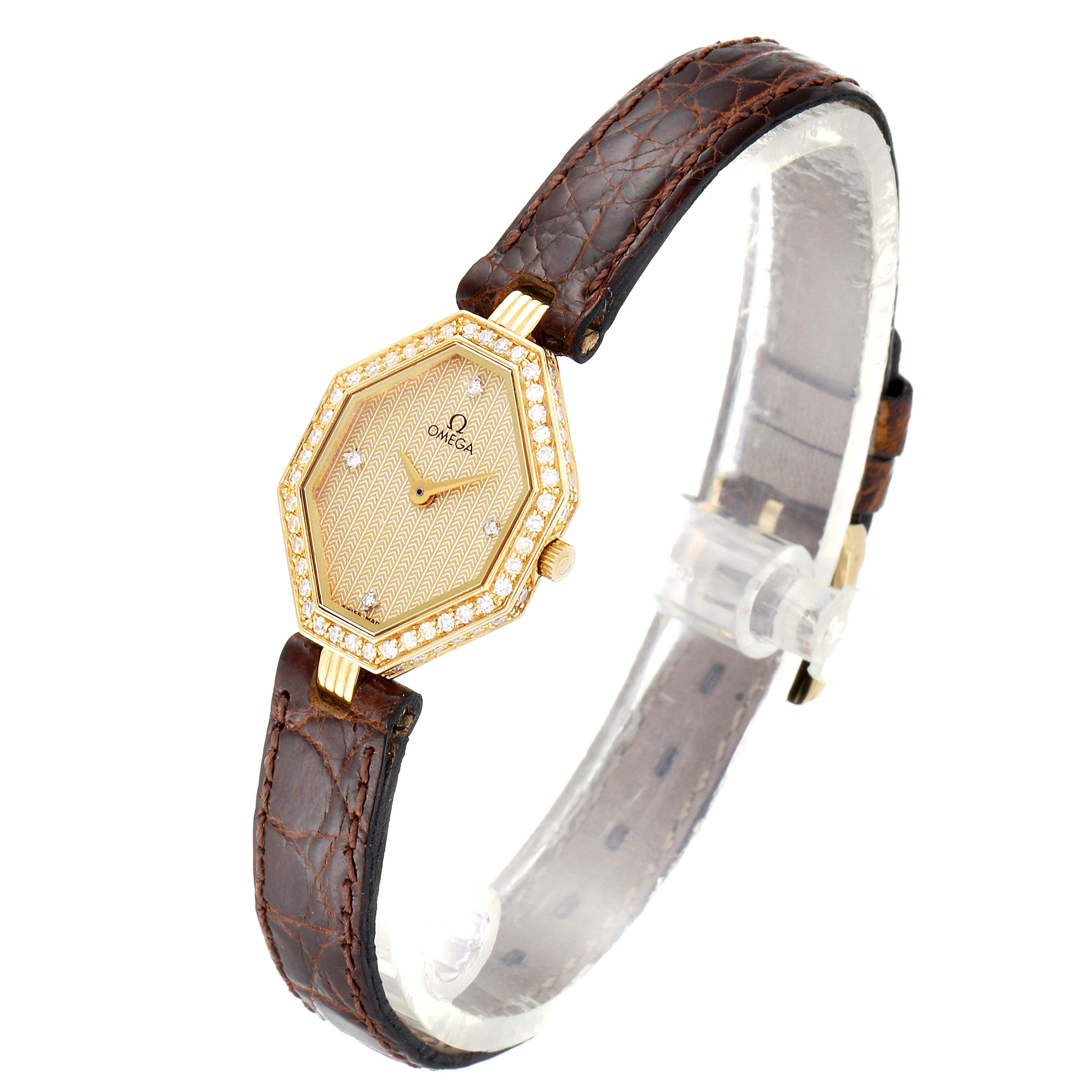 The image shows an Omega 1450 Women's Yellow Gold Champagne Dial 1450 Women's Yellow Gold Champagne Dial DeVille Mini Yellow Gold Diamond Cocktail Ladies Watch 1450 from a front angle, highlighting its hexagonal face and leather strap.