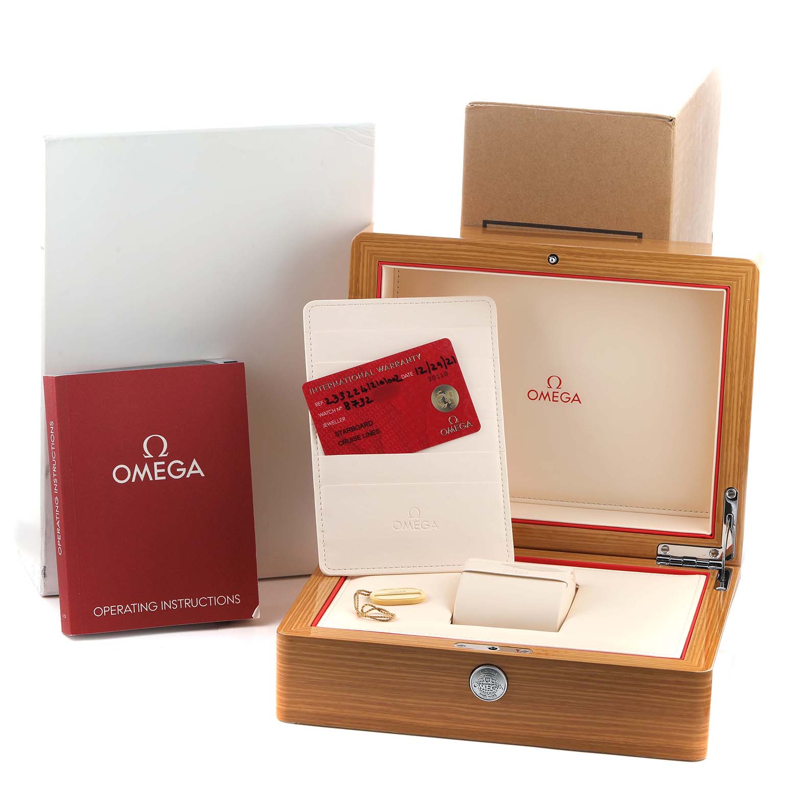 The image shows the Omega Seamaster 233.22.41.21.01.002 Men's Stainless Steel Black Dial's box, operating instructions, warranty cards, and a watch cushion, viewed from the front.