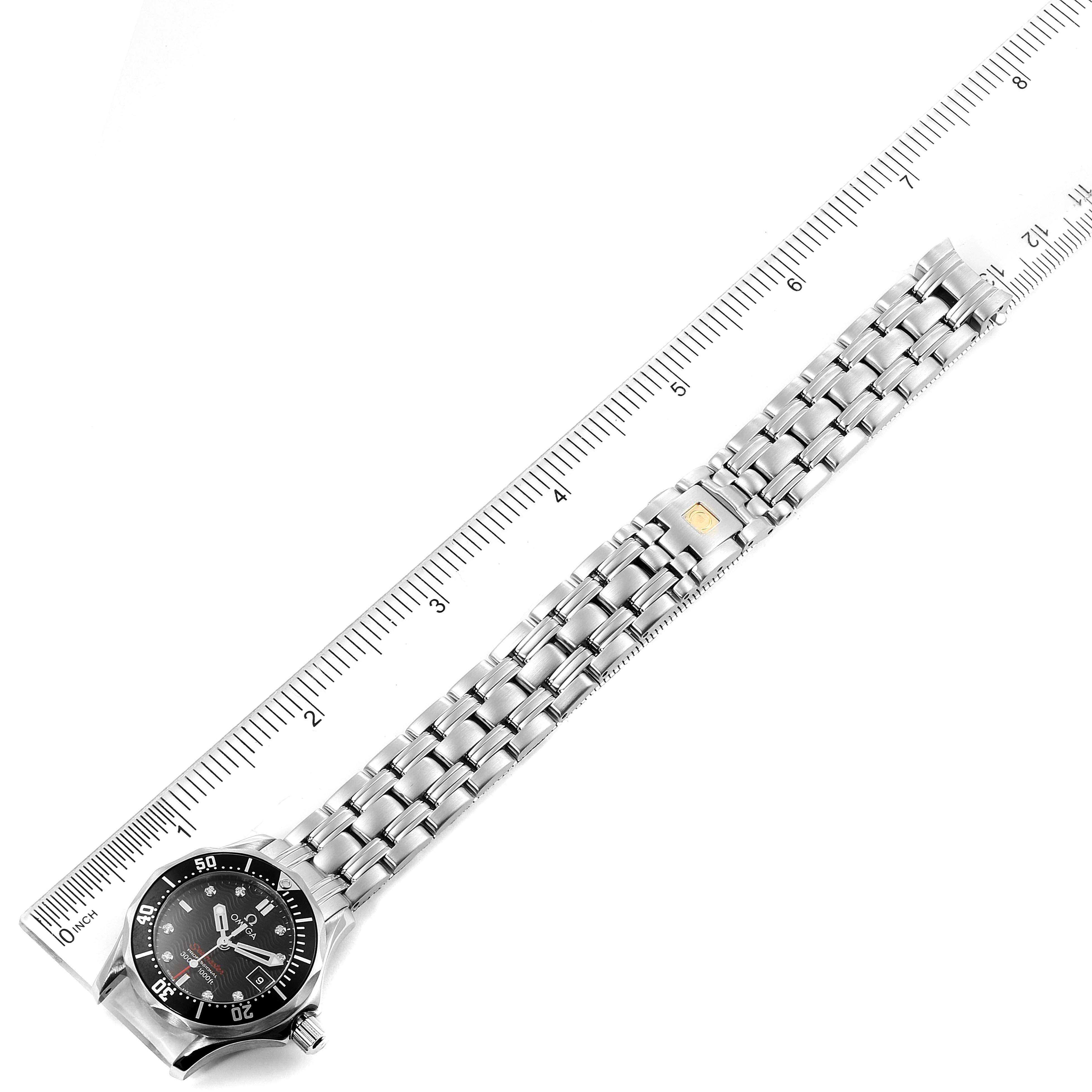 The Omega 212.30.28.61.51.001 Women's Stainless Steel Black Dial 212.30.28.61.51.001 Women's Stainless Steel Black Dial Seamaster Black Dial Diamond Ladies Watch 212.30.28.61.51.001 is shown flat with the dial facing up next to a ruler for scale.