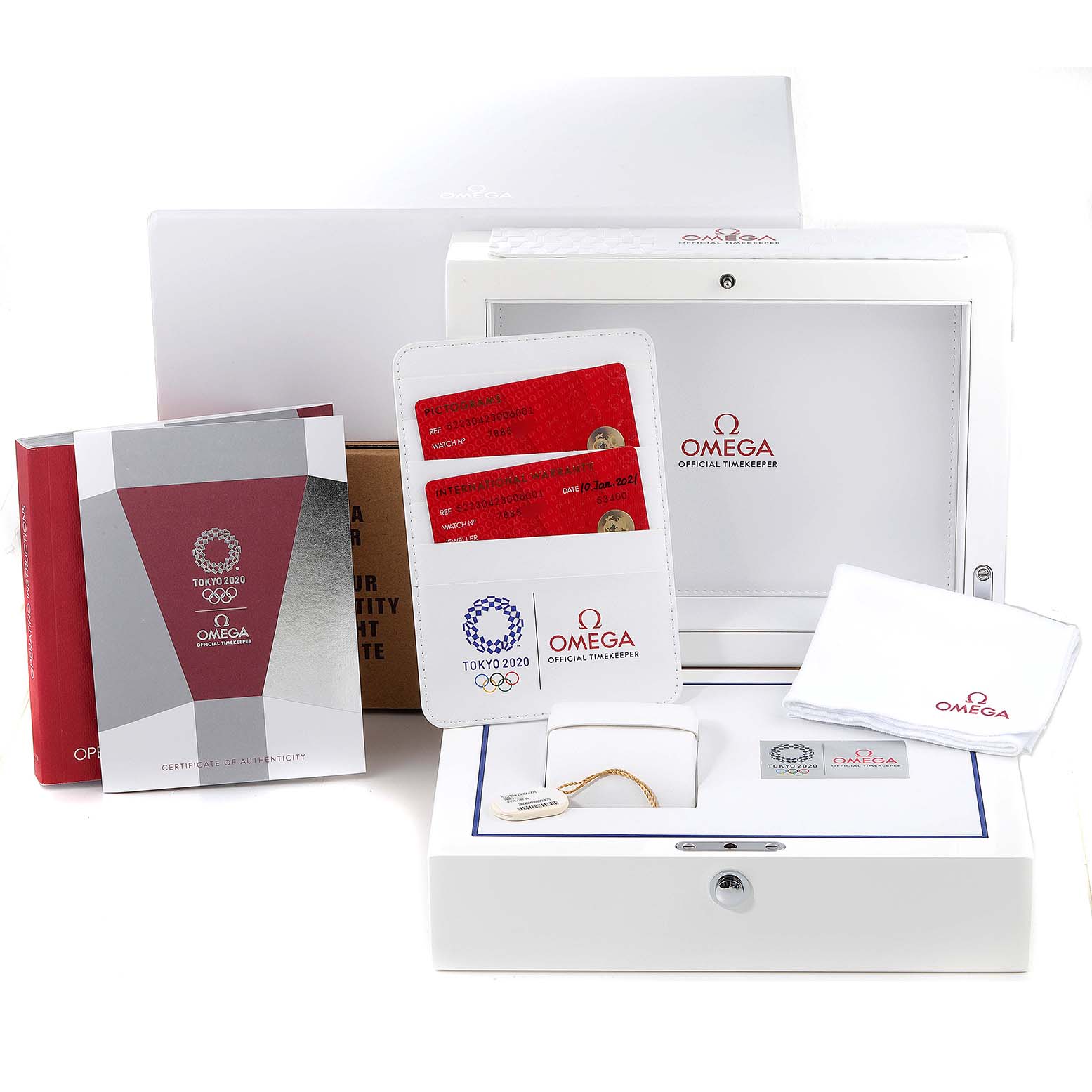The image shows accessories and packaging for the Omega Speedmaster 522.30.42.30.06.001 Men's Stainless Steel Silver Dial 522.30.42.30.06.001 Men's Stainless Steel Silver Dial, including a box, certificates, cards, and a cloth.